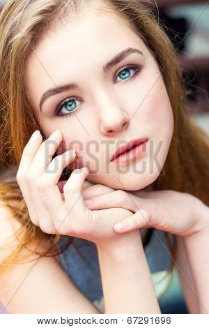 dear beautiful elegant young girl with blue eyes with regime hair seated at the table