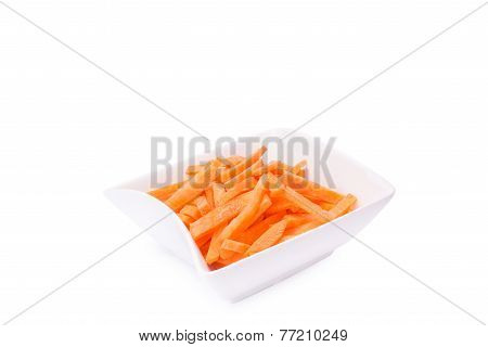 fresh grated carrots on a plate isolated on white background
