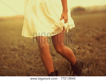 Woman running in the field in autumn