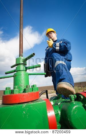 Worker on the oil field. Refinery, oil and gas