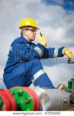 Worker on the oil field. Refinery, oil and gas