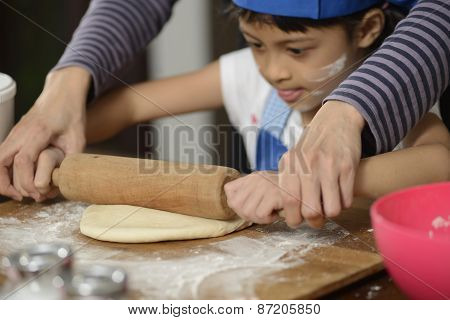 Mother Teaching Her Daughter Making Bread