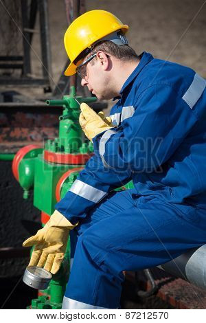 Worker on the oil field. Refinery, oil and gas