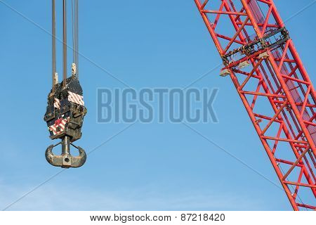 Red Crane Boom With Hook Against Blu Sky