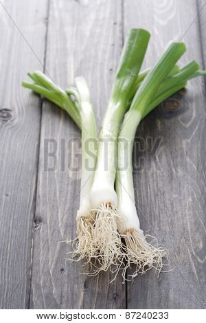 Leeks on wooden table - studio shot