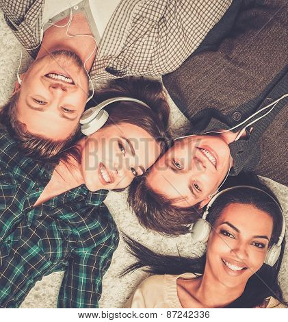 Happy multiracial friends listens music