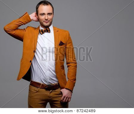 Cheerful sharp dressed fashionist wearing jacket and bow tie