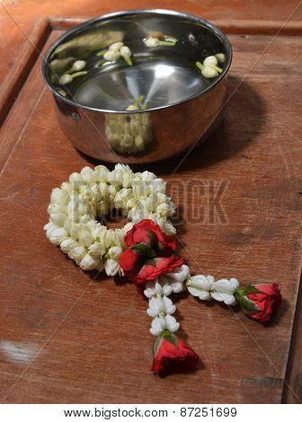 rose garland and jasmine in silver bowl