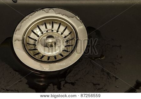 Metal sifter at kitchen sink