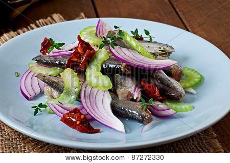 Herring salad with sun-dried tomatoes, celery and red onion