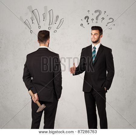 Ruthless businessman handshake with drawn exclamation and question marks around them head