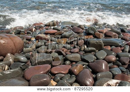 Pebbles on the Beach Being Washed by Wave