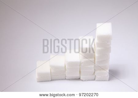 Ascending stacks of sugar cubes - high blood sugar risk concept