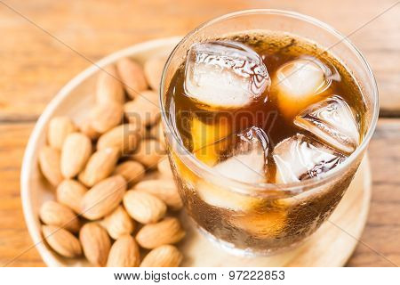 Glass Of Black Iced Coffee With Almond Grain