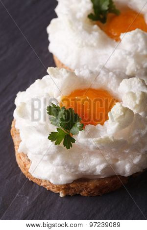 Eggs Orsini: Baked Whipped Whites And Yolk On Toast. Vertical Close-up