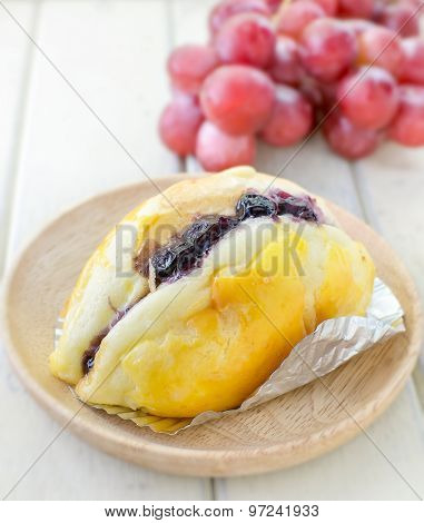 Butter Bread Top Up With Blueberry Sauce With Grape Background