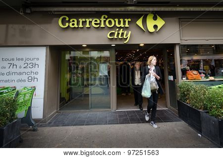 Woman leaves Carrefour City with her groceries