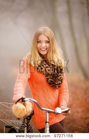Girl Relaxing In Autumnal Park With Bicycle