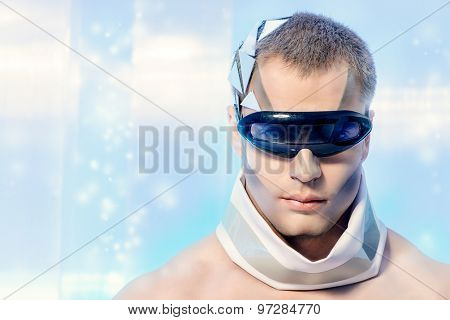 Close-up portrait of a handsome man with futuristic make-up and hairstyle standing on a luminous transparent background. 