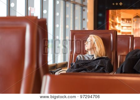 Tired female traveler waiting for departure.