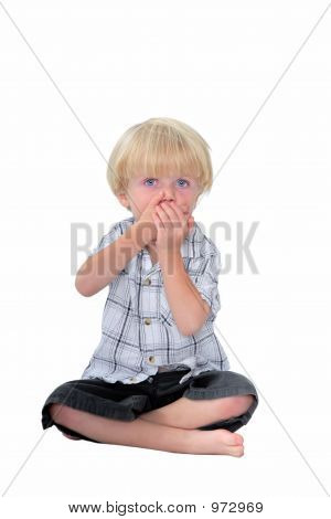 Young Boy With His Hands Over His Mouth And White Background