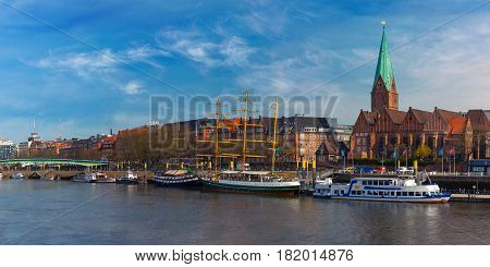 Embankment of the Weser River and Protestant Lutheran Saint Martin Church in the old town of Bremen, Germany. Panoramic view.