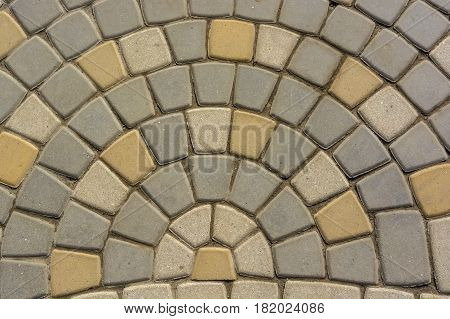 Texture of road surface with grey and yellow pave stones