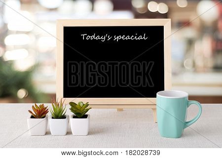 Today's special on blank chalk board over blur restaurant background food and drinks list background