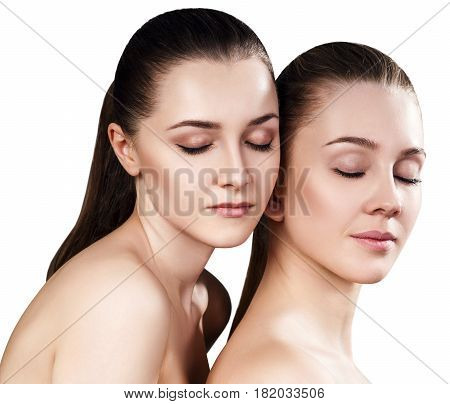 Two beautiful sensual young women with closed eyes. Isolated on white.