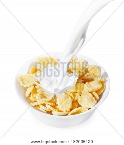 corn flakes with milk splash isolated on white background. Milk pouring into a white bowl of cornflakes. Healthy breakfast