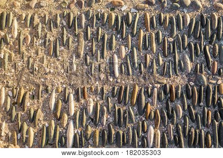 Background wall made of stone. Fragment of a wall from a chipped stone