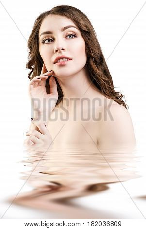 Young beautiful woman with reflection on water surface