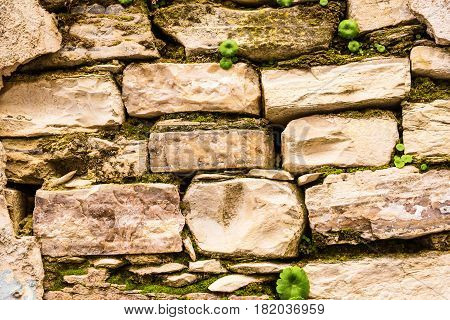 Background wall made of stone. Fragment of a wall from a chipped stone