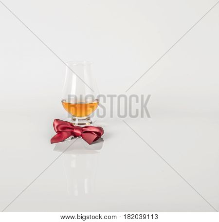 Single Malt Tasting Glass, Single Malt Whisky In A Glass, White Background, Red Bow