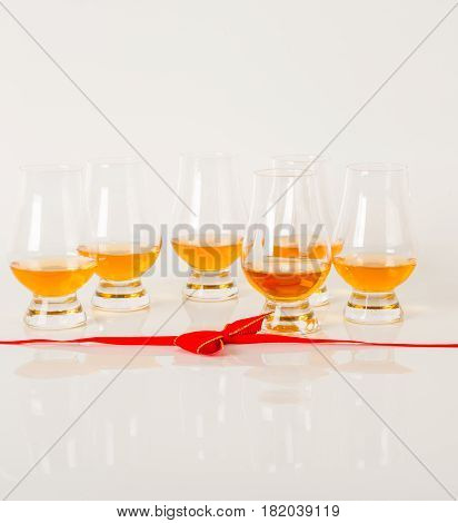 Set Of Single Malt Tasting Glasses, Single Malt Whisky In A Glasses, White Background, Red Bow
