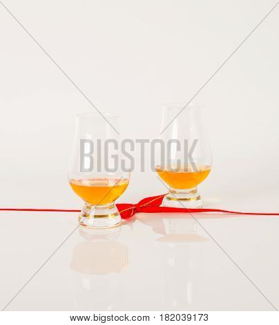 Set Of Single Malt Tasting Glasses, Single Malt Whisky In A Glasses, White Background, Red Bow
