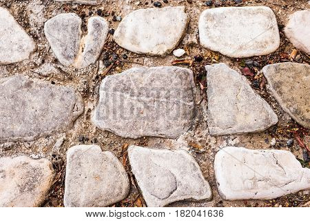 Background wall made of stone. Fragment of a wall from a chipped stone