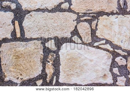 Background wall made of stone. Fragment of a wall from a chipped stone
