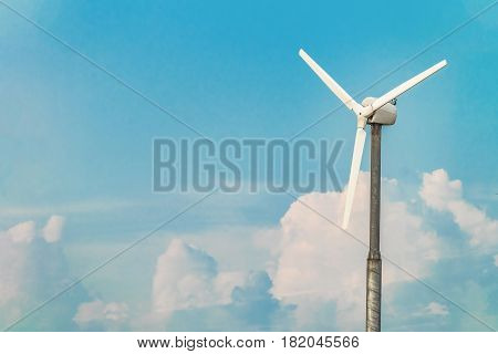 Single wind turbine on the blue sky background. Alternative energy.