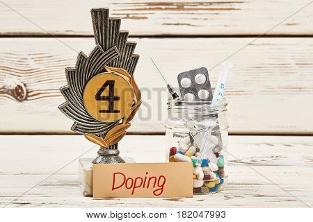 Drugs, award and syringe. Physical activiy with doping.