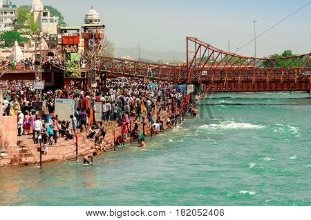Haridwar, India - 2nd Apr 2017 : Crowds on the banks of the river Ganga at Har ki Pauri. This is one of the most holy places in Hinduism. Place to wash away sins.