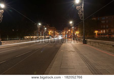 Toulouse, France - October 27, 2016; City lights across Pont Neuf beautifully illuminated on dark night over Garrone River Toulouse France.