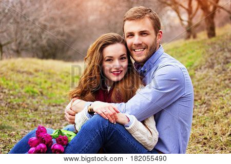 Happiness Is Close To You. Portrait Of Happy Beautiful Young Couple Sitting Together And Smiling On