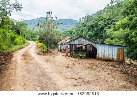 Small Wood Farm House And Dirty Road