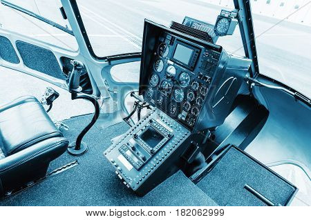 Cockpit helicopter - Instruments panel. Interior of helicopter control dashboard Heli on the ground. Blue colored