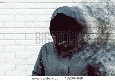 Thinking mind blowing thoughts faceless hooded person against white brick wall