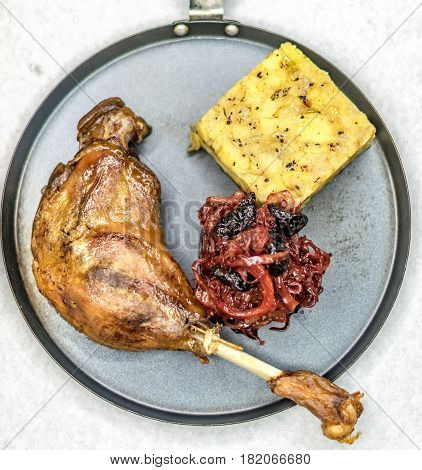 Roasted goose leg with red cabbage and mashed potatoes