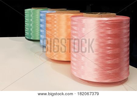 Closeup of spools of thread and colored sewing for the textile industry