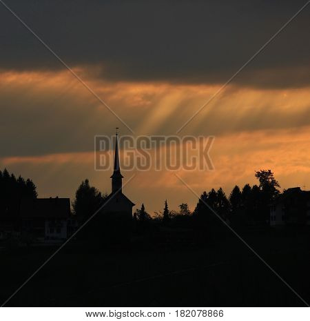 Sunbeams over a small church. Seegraben Switzerland.