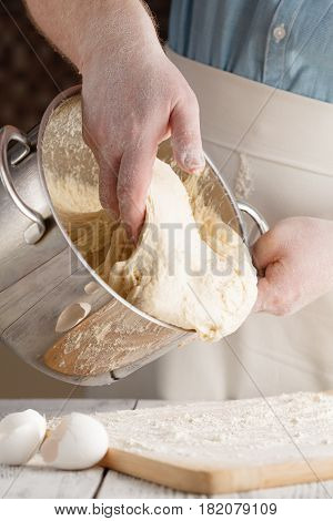 Close Up View Of Baker Kneading Dough. Homemade Bread. Hands Preparing Bread Dough On Wooden Table.